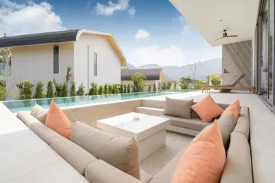 a living room with a couch and a pool at Himmapana Villas - Hills in Kamala Beach