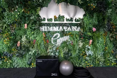 a wall of plants and flowers with a sign at Himmapana Villas - Hills in Kamala Beach