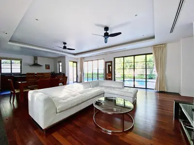 a living room with a white couch and a table at Luxe 2br Pool Villa walk to Bangtao Beach in Ban Thalat Choeng Thale