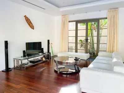 a living room with white furniture and a flat screen tv at Luxe 2br Pool Villa walk to Bangtao Beach in Ban Thalat Choeng Thale