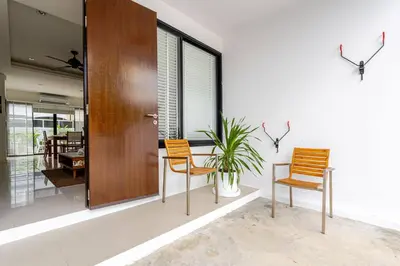 a room with two chairs and a table and a plant at LP 65-57 Spacious holiday home close to the beach in Phuket Town