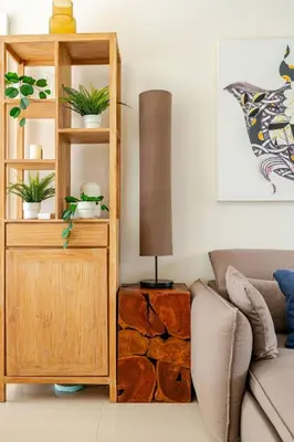 a living room with a wooden book shelf and a lamp at LP 65-57 Spacious holiday home close to the beach in Phuket Town