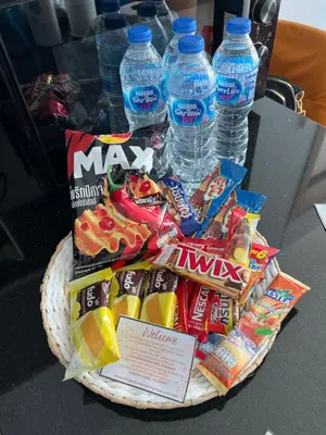 a basket of chips and water bottles on a table at Emerald Terrace Condo 3-Studio Garden Gem in Patong Beach