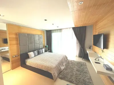 a bedroom with a bed and a flat screen tv at Emerald Terrace Condo 5-Studio Garden zen in Patong Beach