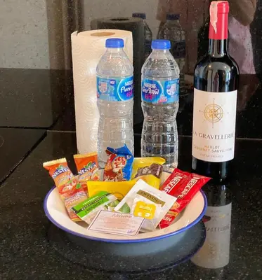 a plate of food and two bottles of wine at Emerald Terrace Condo 5-Studio Garden zen in Patong Beach