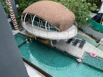 an overhead view of a swimming pool with a circular building at Emerald Terrace Condo 5-Studio Garden zen in Patong Beach