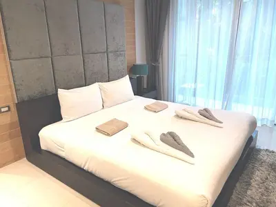 a bedroom with a bed with two slippers on it at Emerald Terrace Condo 5-Studio Garden zen in Patong Beach