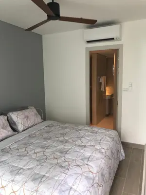 a bedroom with a bed and a ceiling fan at Cassia Residence Laguna Phuket Holiday Rental Apartment, Bang Tao Beach in Phuket Town