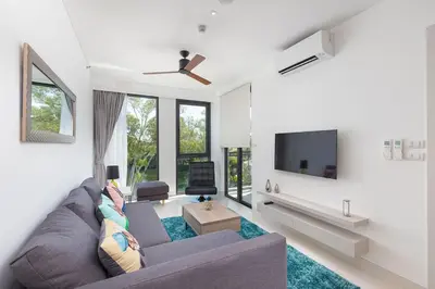 a living room with a couch and a tv at Cassia Residence Laguna Phuket Holiday Rental Apartment, Bang Tao Beach in Phuket Town