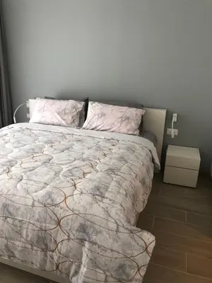 a bedroom with a bed with a comforter on it at Cassia Residence Laguna Phuket Holiday Rental Apartment, Bang Tao Beach in Phuket Town