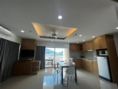 a kitchen with a table and a ceiling fan at Patong Tower Superior Apt 2 bedrooms 2 bathrooms in Patong Beach