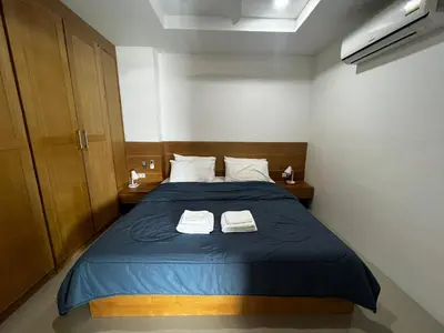a bedroom with a blue bed with two towels at Patong Tower Superior Apt 2 bedrooms 2 bathrooms in Patong Beach