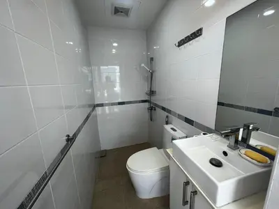 a white bathroom with a toilet and a sink at Patong Tower Superior Apt 2 bedrooms 2 bathrooms in Patong Beach