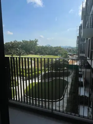 a balcony with a view of a park at Modern Golf course view Apartment in Sky Park Laguna in Phuket Town