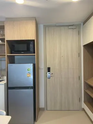 a kitchen with a refrigerator and a microwave at Modern Golf course view Apartment in Sky Park Laguna in Phuket Town