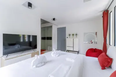a white bedroom with a large white bed and red pillows at Kamala family friendly pool villa by Lofty in Kamala Beach