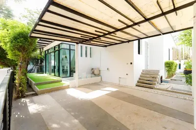 an outdoor patio with awning and a building at Kamala family friendly pool villa by Lofty in Kamala Beach