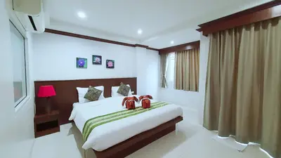 a bedroom with a bed with two shoes on it at Nanai 8 Road \u82ad\u4e1c\u4e00\u5367\u8c6a\u534e\u516c\u5bd3\u4f4d\u7f6e\u4fbf\u5229 in Patong Beach