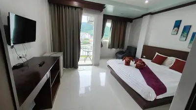 a bedroom with a bed with two teddy bears on it at Nanai 8 Road \u82ad\u4e1c\u4e00\u5367\u8c6a\u534e\u516c\u5bd3\u4f4d\u7f6e\u4fbf\u5229 in Patong Beach