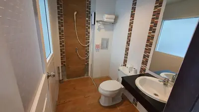 a bathroom with a toilet and a sink and a shower at Nanai 8 Road \u82ad\u4e1c\u4e00\u5367\u8c6a\u534e\u516c\u5bd3\u4f4d\u7f6e\u4fbf\u5229 in Patong Beach
