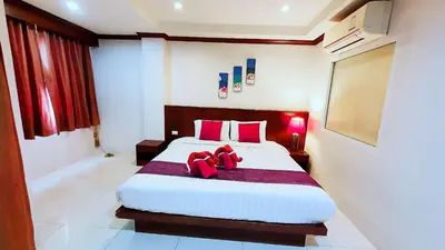 a bedroom with a large bed with red pillows at Nanai 8 Road \u82ad\u4e1c\u4e00\u5367\u8c6a\u534e\u516c\u5bd3\u4f4d\u7f6e\u4fbf\u5229 in Patong Beach