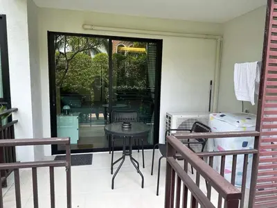 a patio with a table and chairs and a window at Studio Title III, Rawai Phuket in Rawai Beach