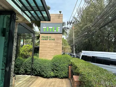 a building with a sign for a hotel at Studio Title III, Rawai Phuket in Rawai Beach