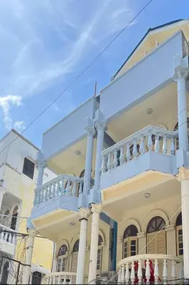 a large white house with a white balcony at Sonya Residence in Patong Beach