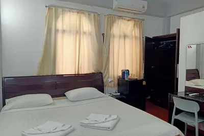a bedroom with a large bed with two towels on it at Sonya Residence in Patong Beach
