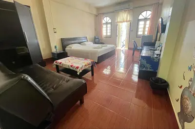 a living room with a bed and a couch at Sonya Residence in Patong Beach