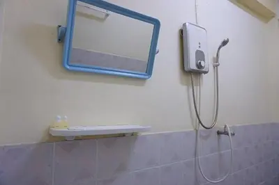 a mirror on the wall of a bathroom with a shower at Sonya Residence in Patong Beach