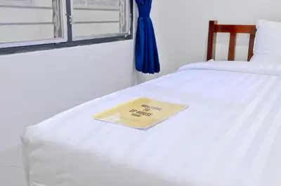 a sign on a bed with a napkin on it at GP House Krabi Aonang Beach in Ao Nang Beach