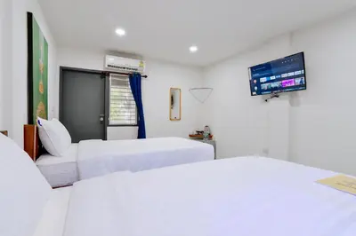 a hospital room with two beds and a flat screen tv at GP House Krabi Aonang Beach in Ao Nang Beach