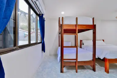 a bedroom with a bunk bed and a window at GP House Krabi Aonang Beach in Ao Nang Beach