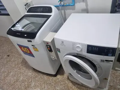 a white washing machine next to a white microwave at GP House Krabi Aonang Beach in Ao Nang Beach