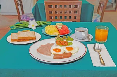 a blue table with plates of breakfast food on it at Anyavee Aonang Bay in Ao Nang Beach