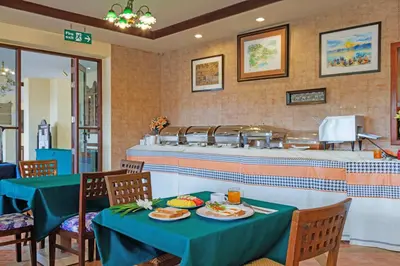 a restaurant with a table with plates of food on it at Anyavee Aonang Bay in Ao Nang Beach