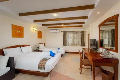 a hotel room with two beds and a desk and a computer at Anyavee Aonang Bay in Ao Nang Beach