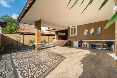 a patio of a house with a table and chairs at Cheeva Pool Villa Phuket in Phuket Town