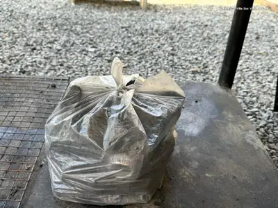 a plastic bag sitting on top of a rock at Cheeva Pool Villa Phuket in Phuket Town