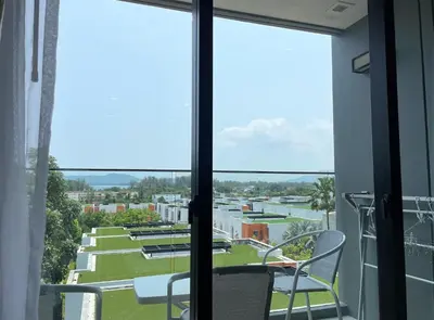a view from the balcony of a building at Luxury sea view apartment at Mida Grande in Surin Beach