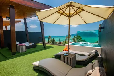a patio with an umbrella and a swimming pool at Villa Sabine private pool 4br seaview jacuzzi in Rawai Beach