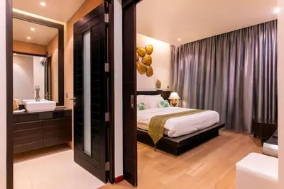 a bedroom with a bed and a bathroom with a sink at Villa Sabine private pool 4br seaview jacuzzi in Rawai Beach