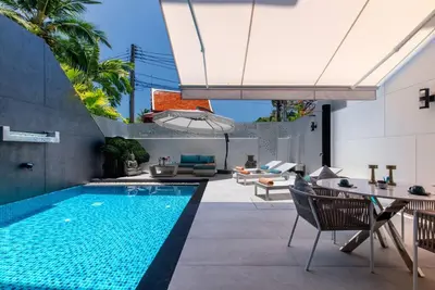 a swimming pool in a backyard with a house at Villa Sabine private pool 4br seaview jacuzzi in Rawai Beach