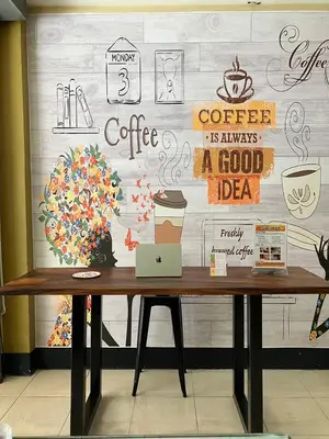 a table with a laptop on it in front of a wall at Cozy Place in Patong Beach