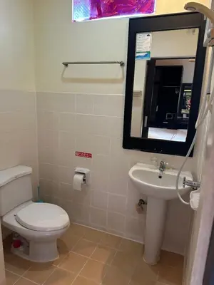 a bathroom with a toilet and a sink and a mirror at Cozy Place in Patong Beach