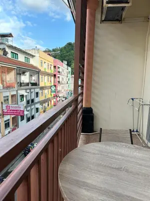 a table on a balcony with a view of a city at Cozy Place in Patong Beach