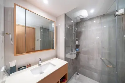 a bathroom with a sink and a shower at Laguna Beachside 1 bedroom apartment 2 minutes from the beach in Phuket Town