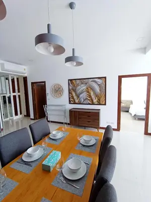 a dining room with a table with chairs and a table at Smart Conzept 2bdr 300m to the sea in Kata Beach