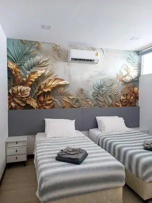 two beds in a room with a mural on the wall at Smart Conzept 2bdr 300m to the sea in Kata Beach